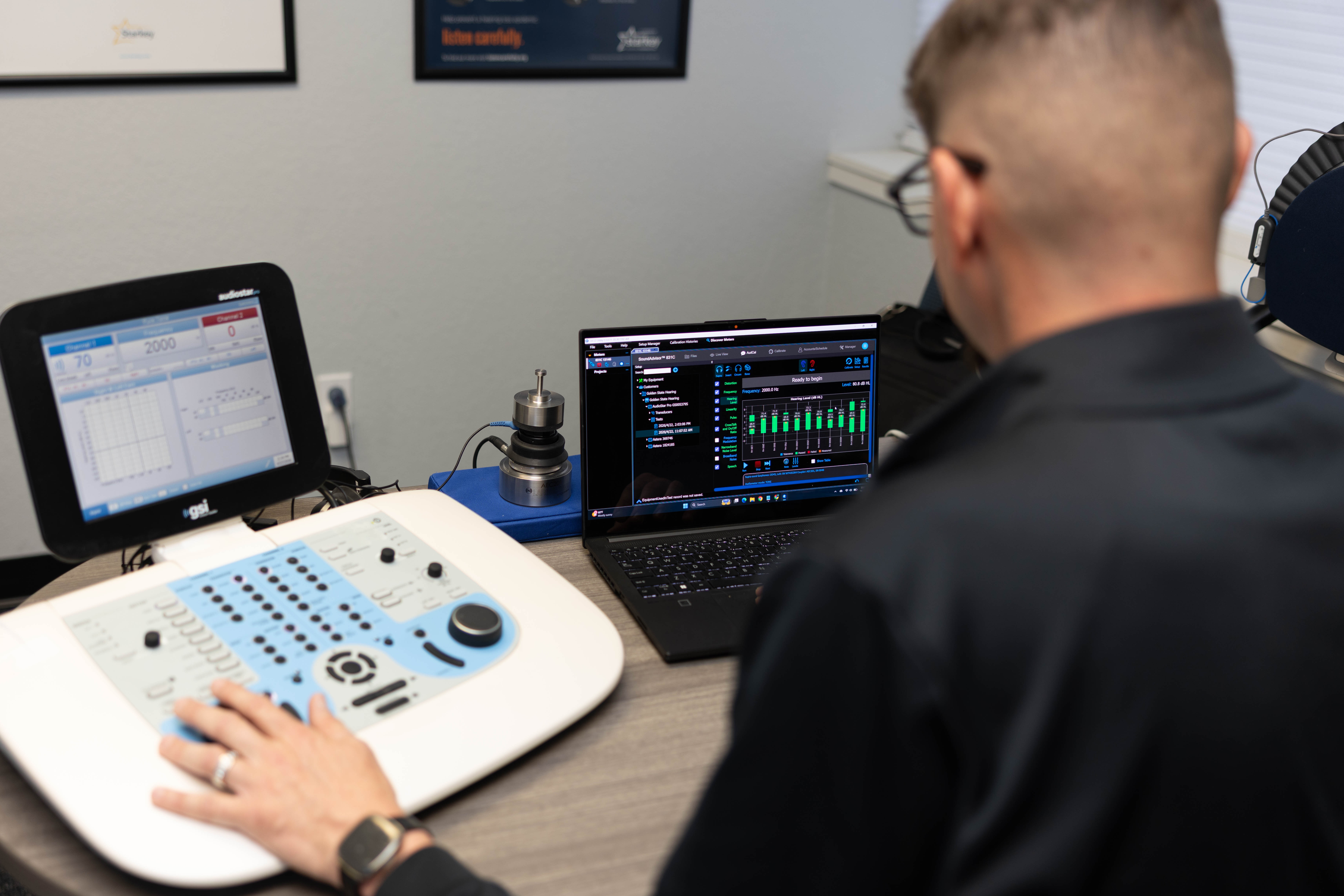 Over-shoulder view of calibration equipment and software during an audiometer calibration